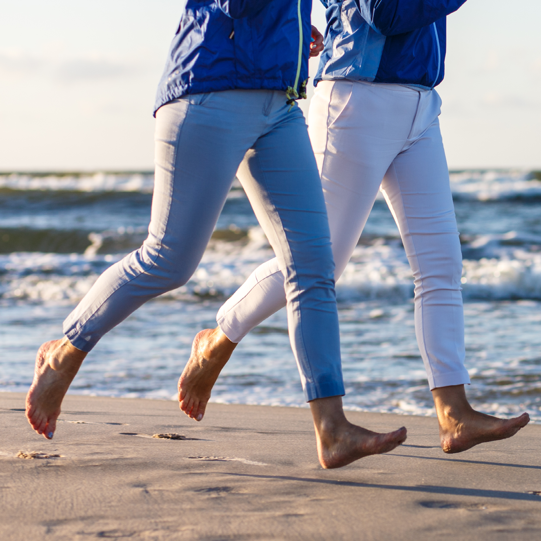 Kvinde og mand løber på stranden